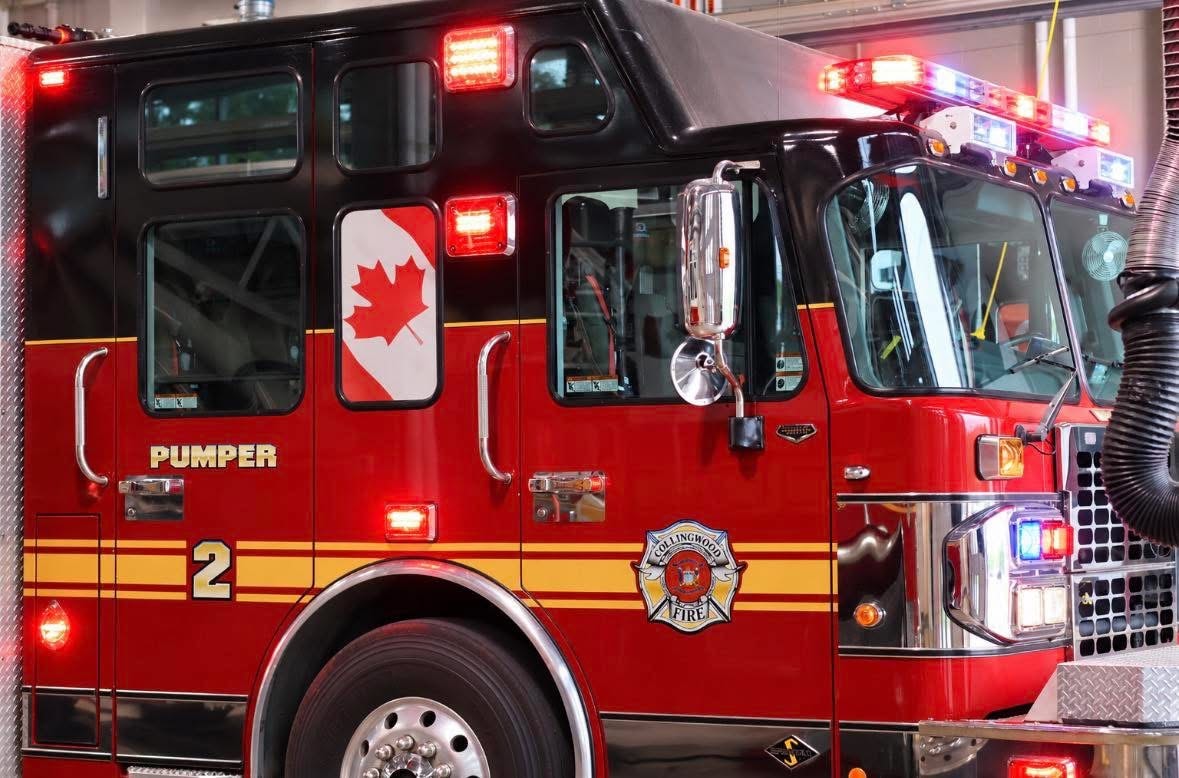 Collingwood Fire pumper with hose deployed at an urban emergency scene